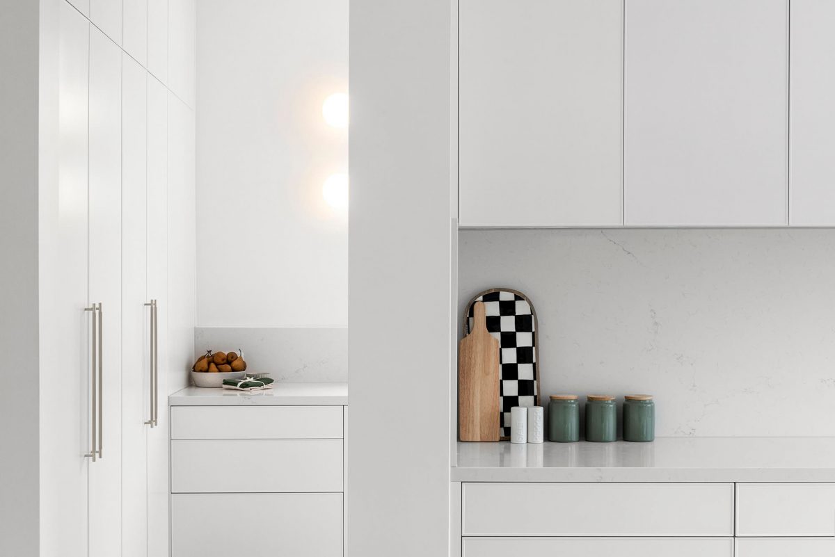 A custom designed kitchen featuring white custom joinery. Designed and built by MJ Harris Group. #MJHxFitzgibbonCres