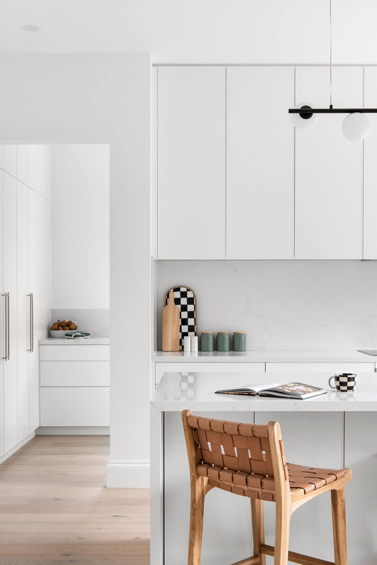 A custom designed kitchen featuring white custom joinery. Designed and built by MJ Harris Group. #MJHxFitzgibbonCres