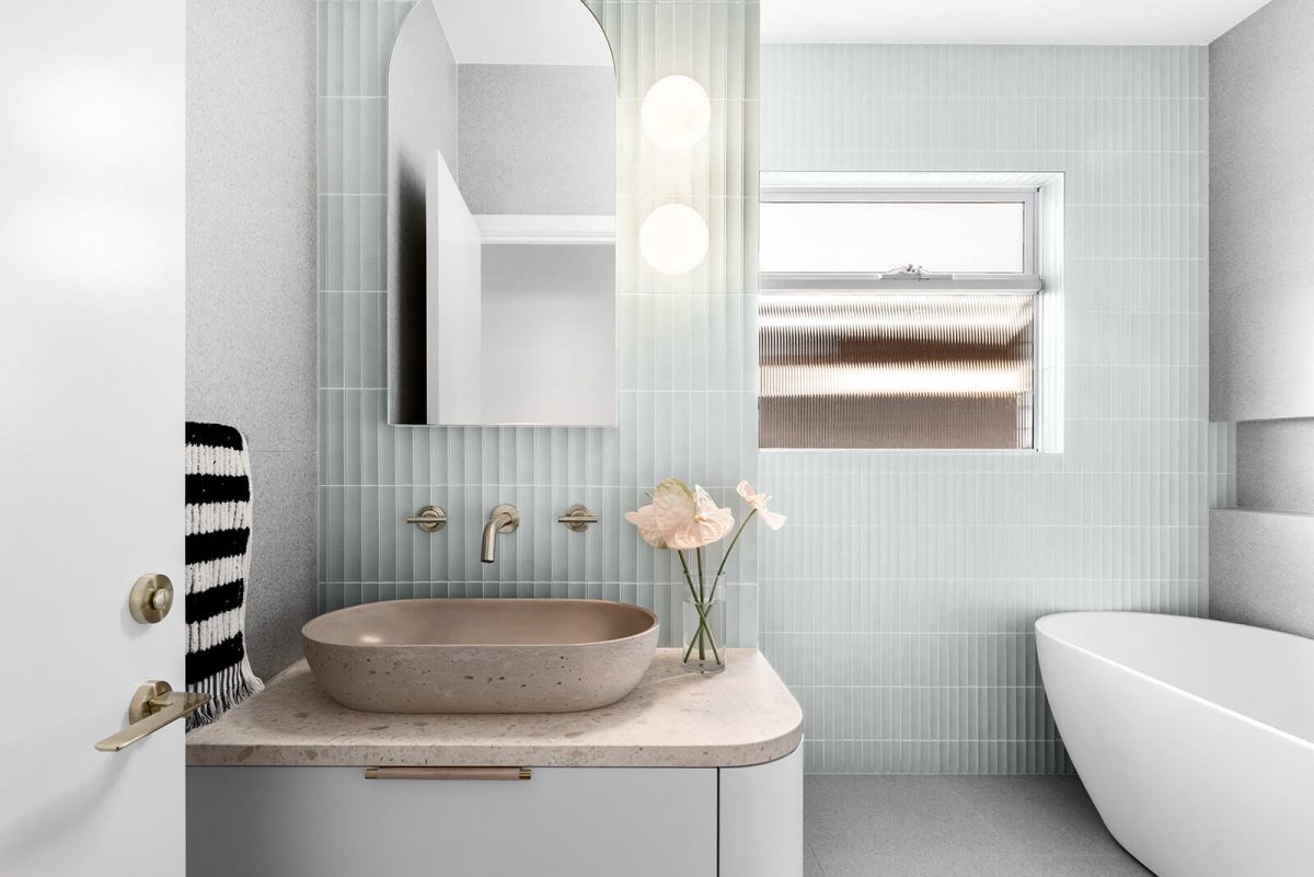 A custom designed bathroom featuring green concave kit kat tile feature wall and a free standing bathtub. Designed and built by MJ Harris Group. #MJHxNaroomaSt