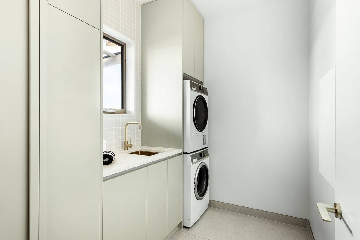 A custom designed laundry featuring gold tapware. Designed and built by MJ Harris Group. #MJHxNaroomaSt