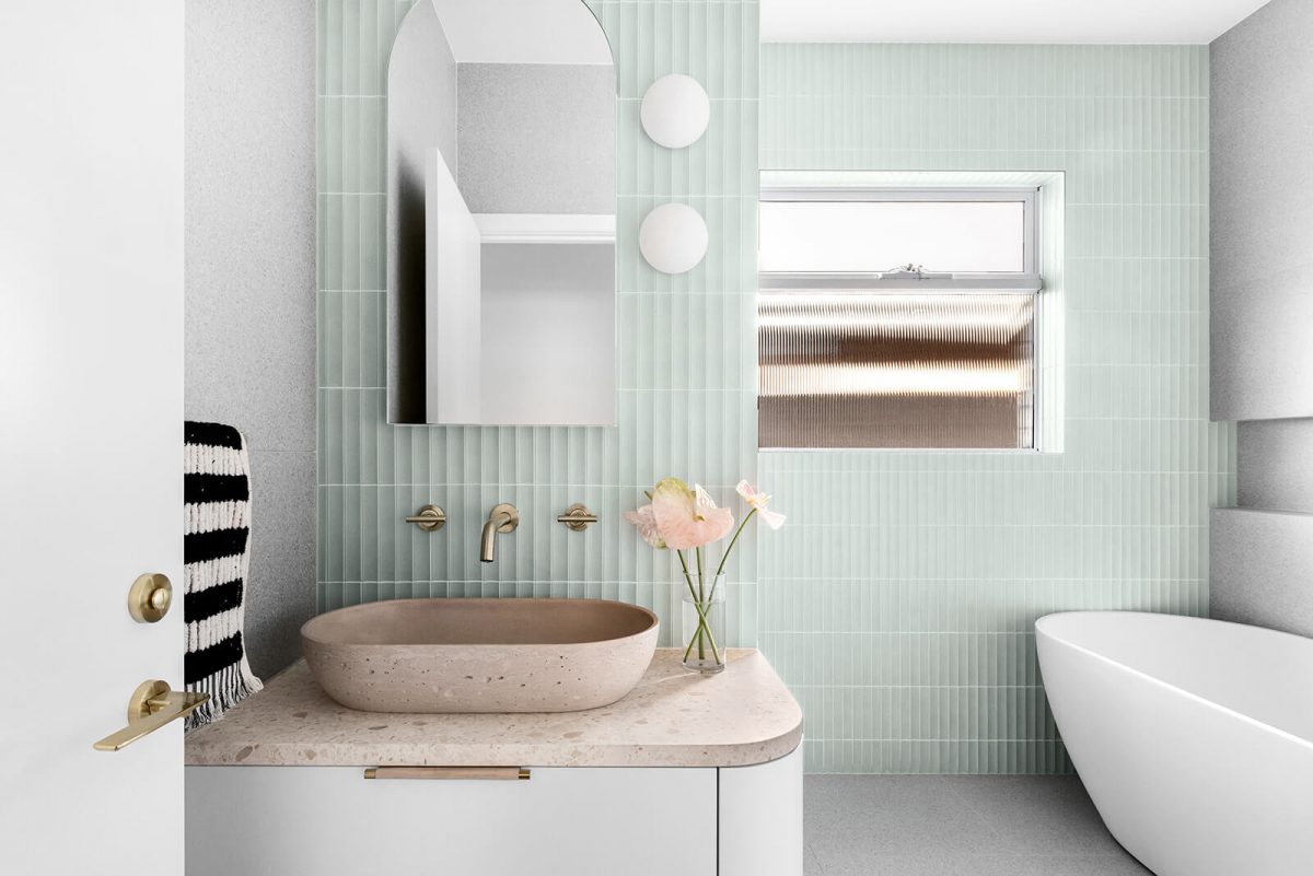 A custom designed bathroom featuring green concave kit kat tile feature wall and a free standing bathtub. Designed and built by MJ Harris Group. #MJHxNaroomaSt