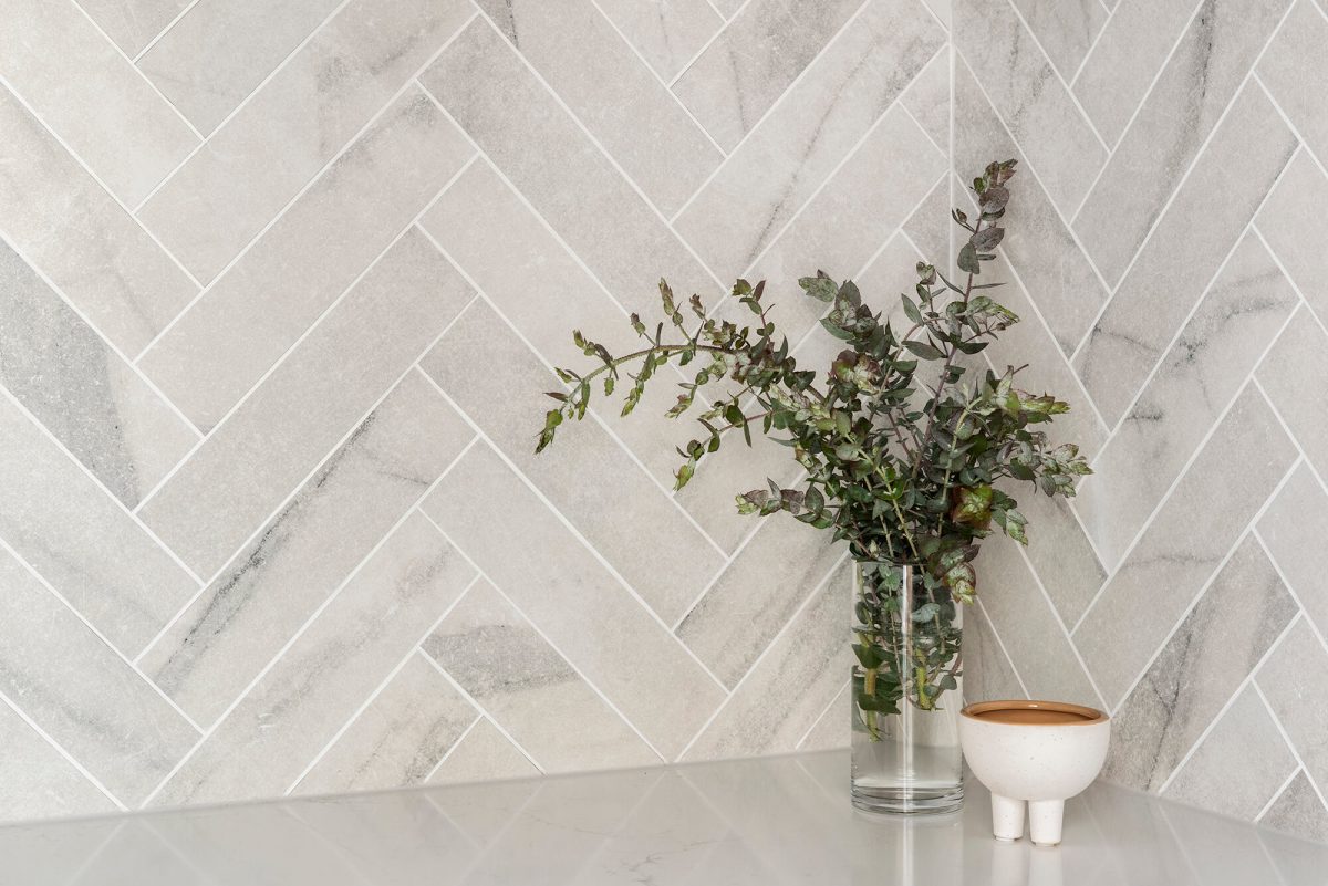 A custom designed laundry featuring a tiled herringbone splashback. Designed and built by MJ Harris Group. #MJHxBaySt