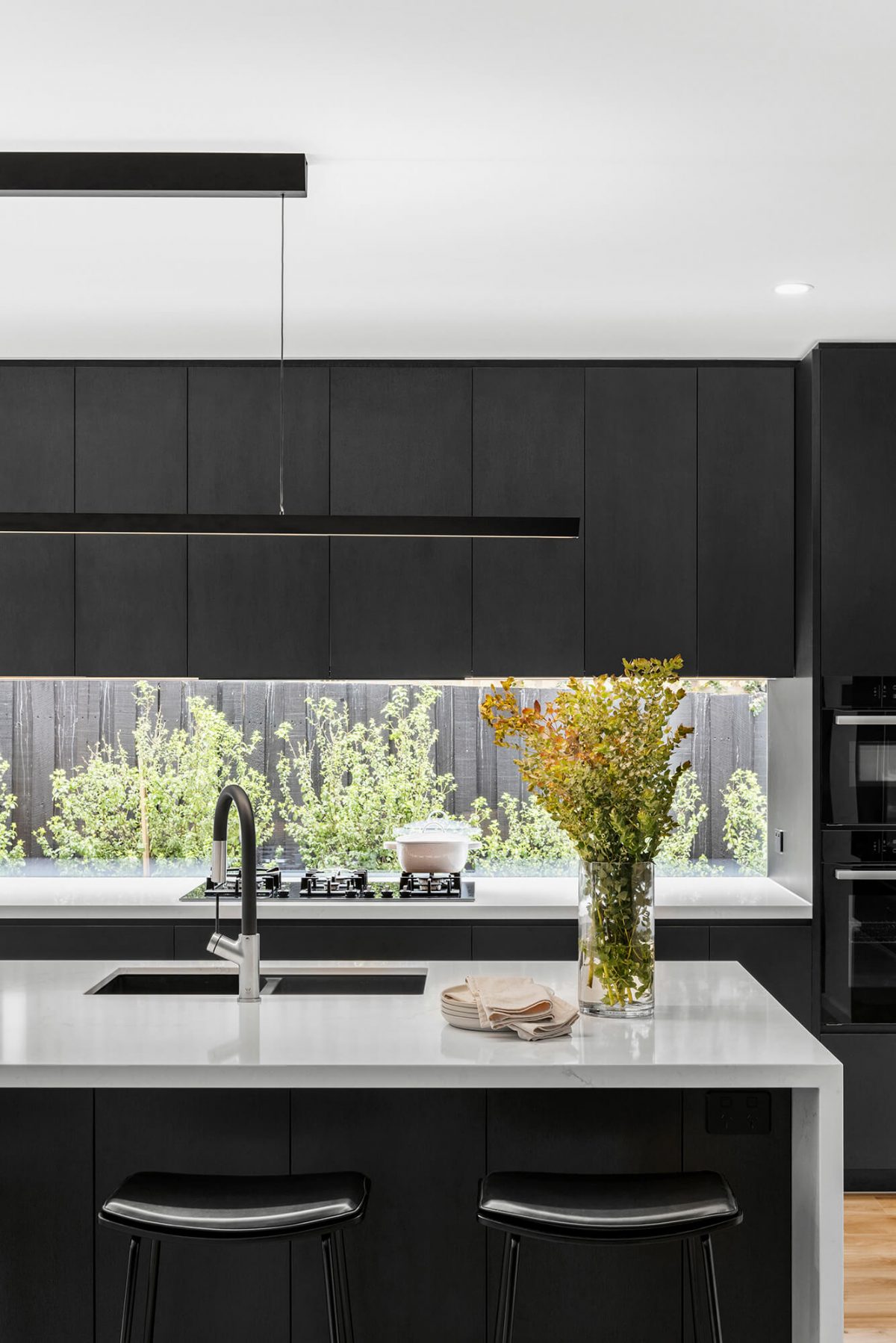 A custom designed bathroom featuring a monochrome style. Designed and built by MJ Harris Group. #MJHxBaySt
