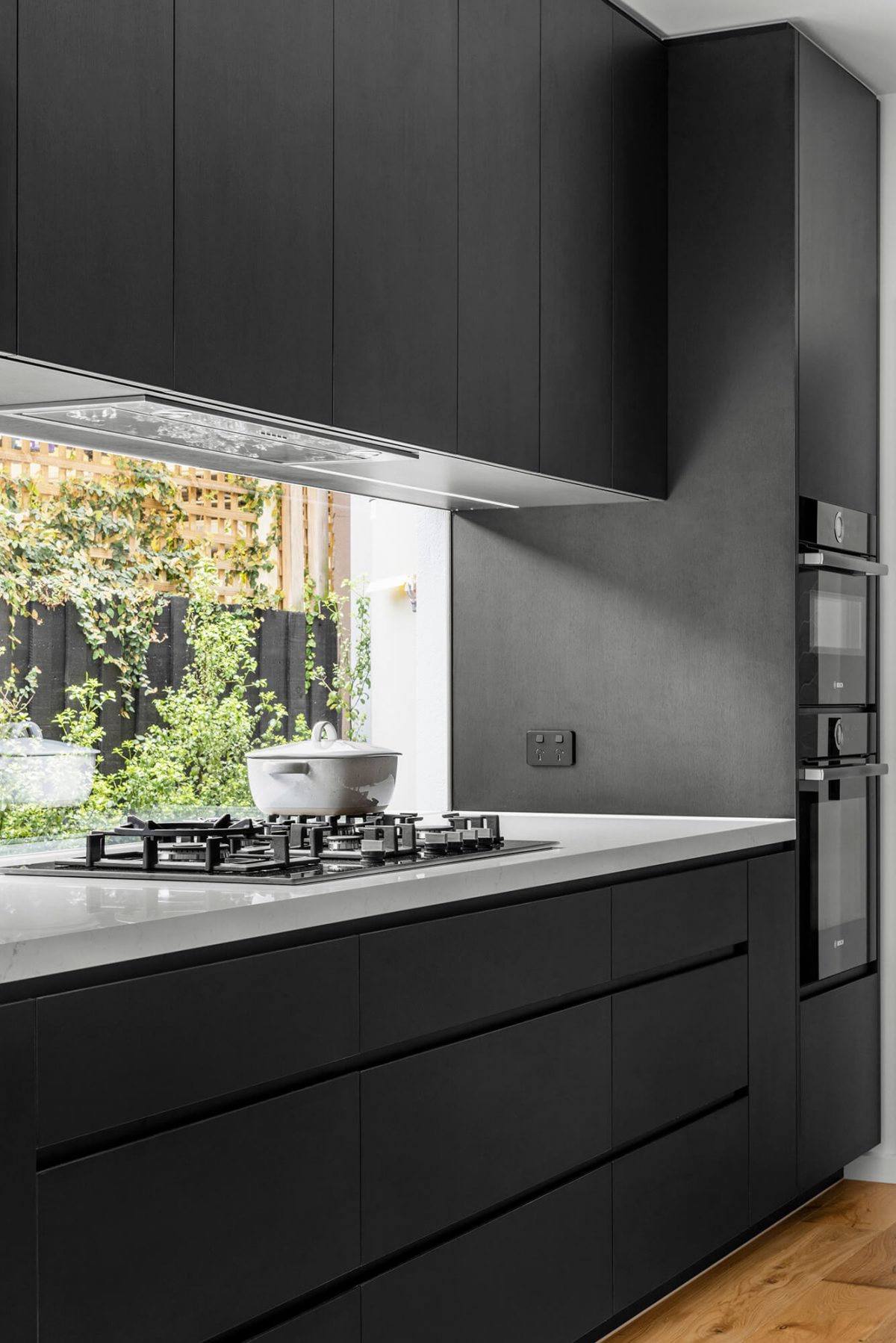 A custom designed kitchen featuring a monochrome style. Designed and built by MJ Harris Group. #MJHxBaySt