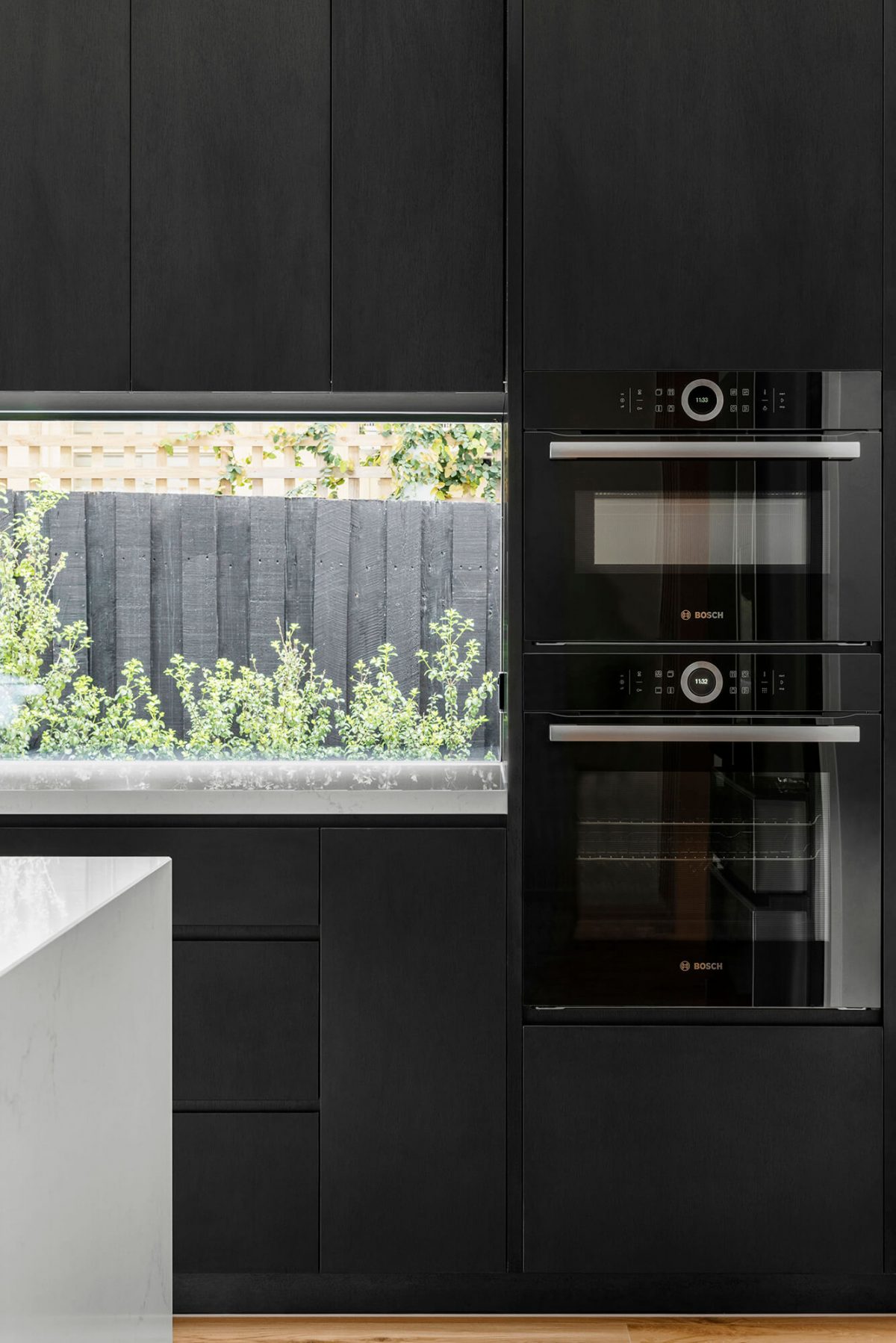 A custom designed kitchen featuring a monochrome style. Designed and built by MJ Harris Group. #MJHxBaySt