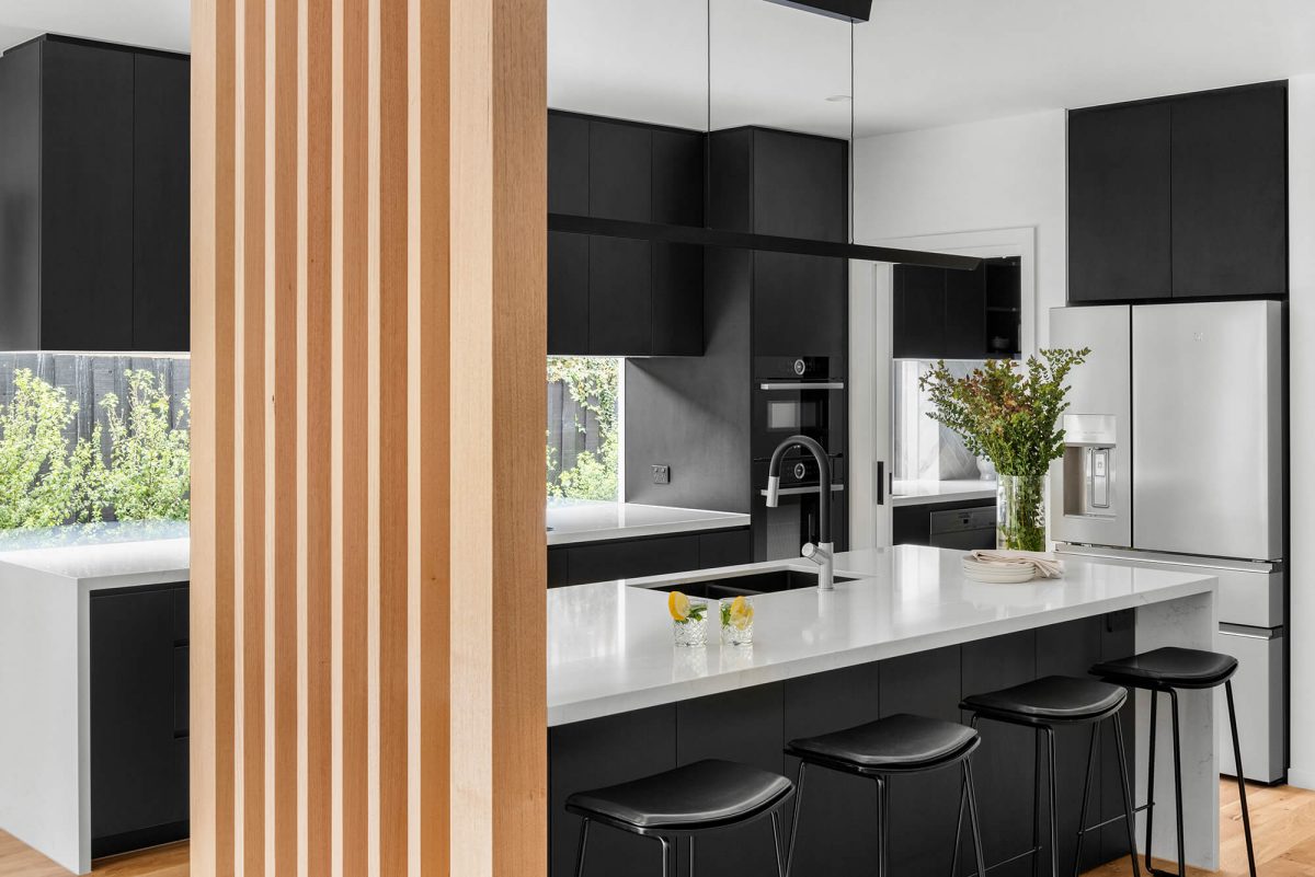 A custom designed kitchen featuring a monochrome style and timber batten. Designed and built by MJ Harris Group. #MJHxBaySt