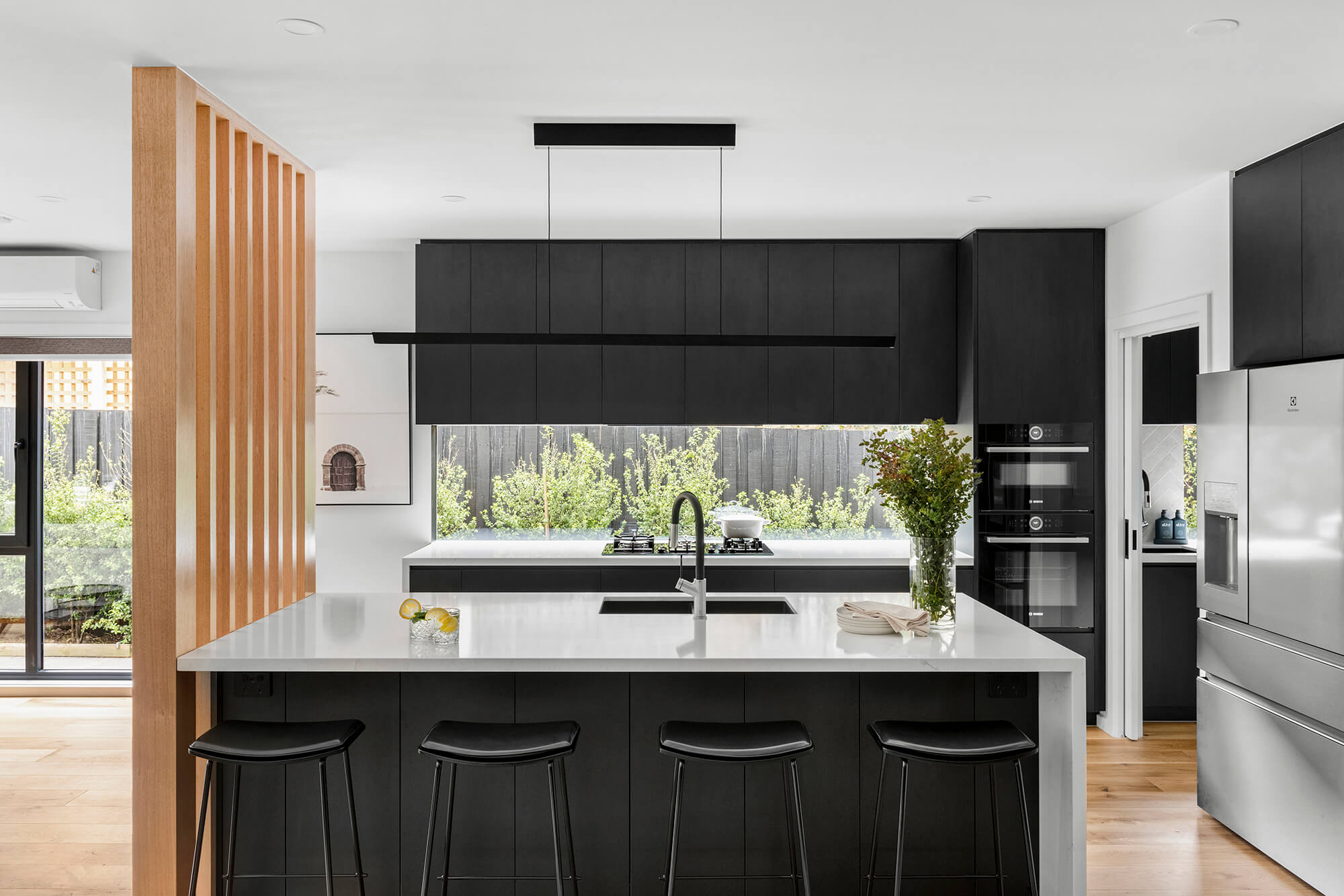 Black Kitchen Renovation in Brighton, Melbourne. Timber Batten Wall Stone Benchtop Butlers Pantry