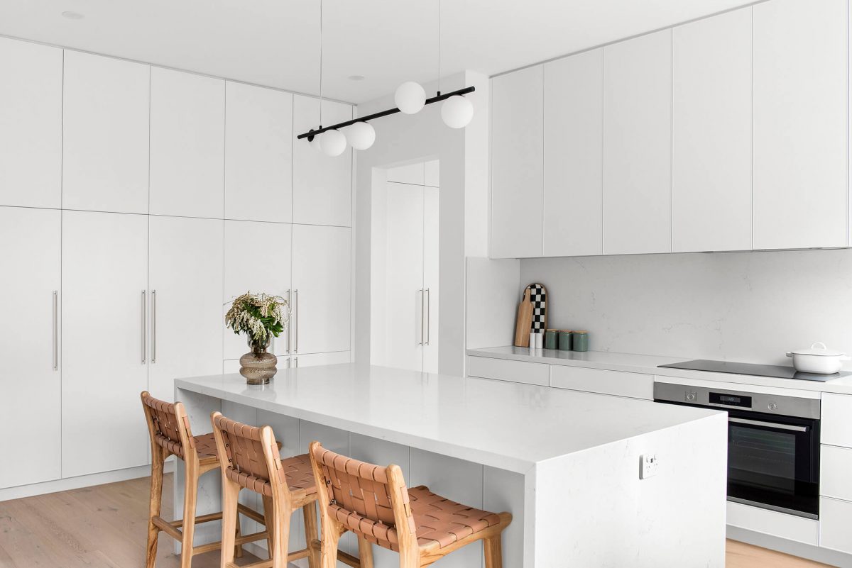 A custom designed kitchen featuring white custom joinery. Designed and built by MJ Harris Group. #MJHxFitzgibbonCres
