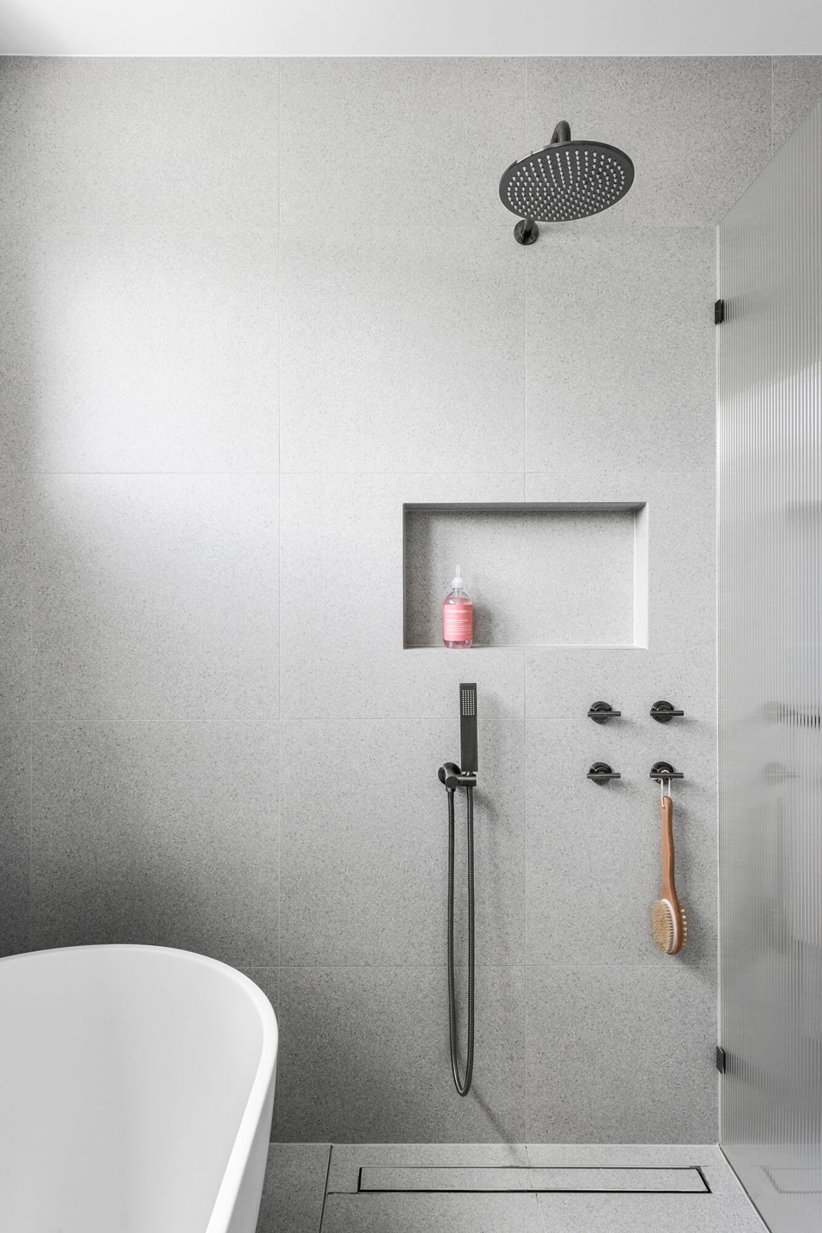 A custom designed bathroom featuring a walk in shower and brushed gunmetal tapware. Designed and built by MJ Harris Group. #MJHxGlencairnAve