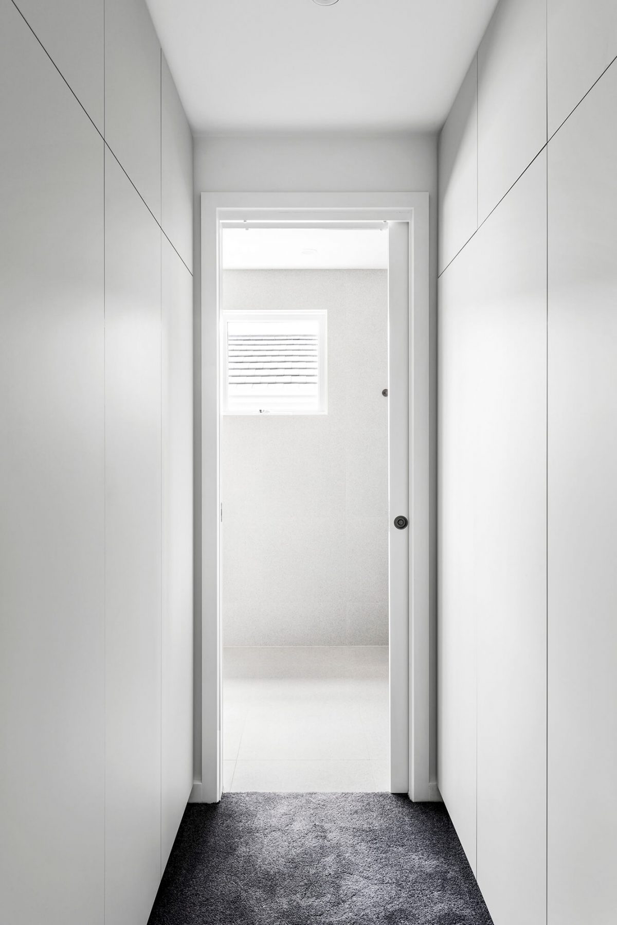 A custom designed walk in robe featuring floor to ceiling custom joinery. Designed and built by MJ Harris Group. #MJHxGlencairnAve