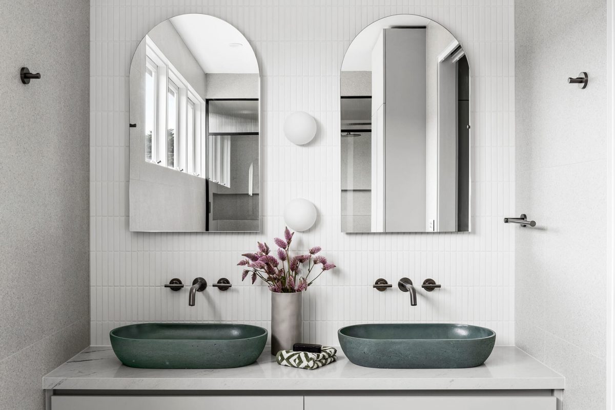 A custom designed bathroom featuring an olive green basin and brushed gunmetal tapware. Designed and built by MJ Harris Group. #MJHxGlencairnAve