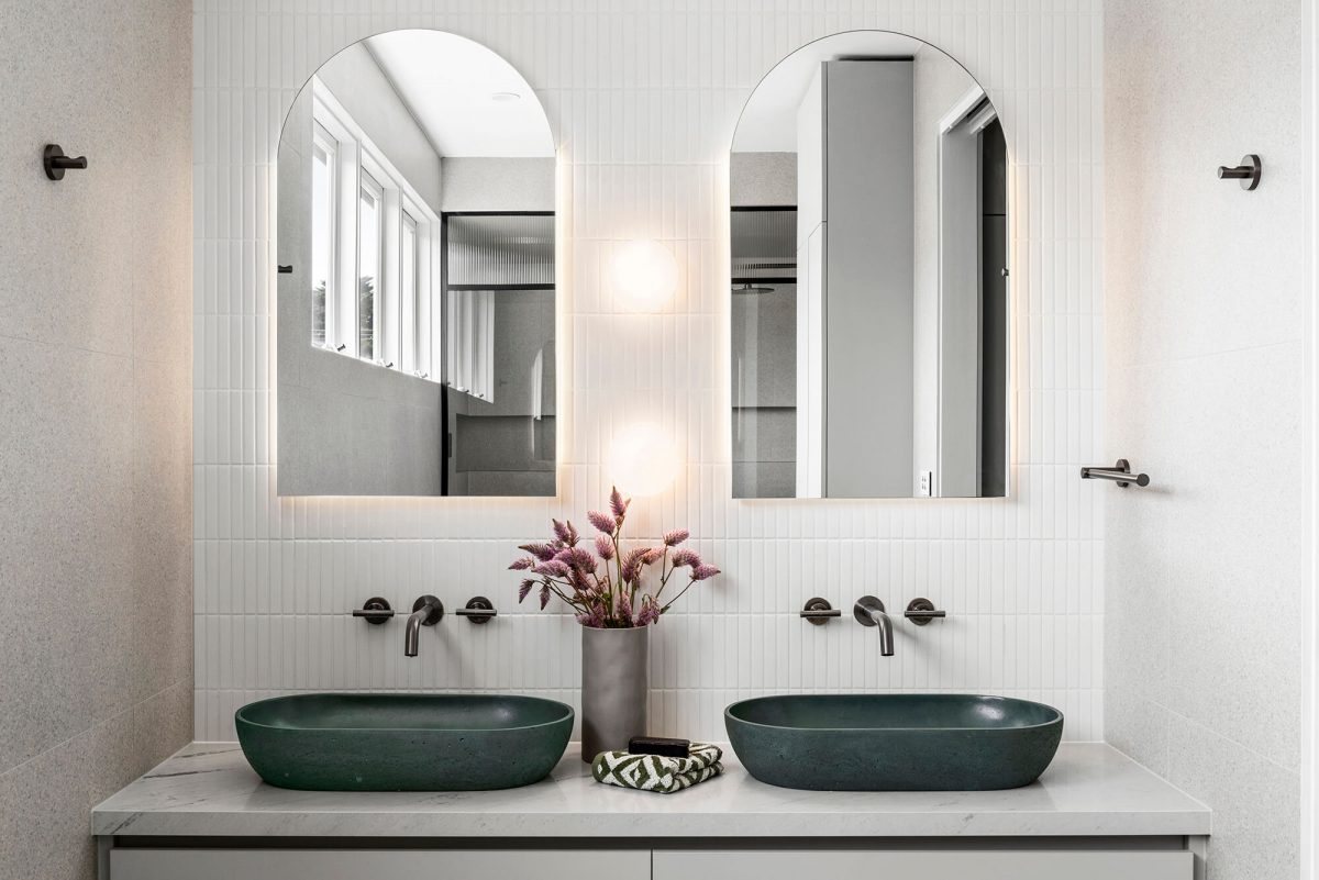 A custom designed bathroom featuring an olive green basin and brushed gunmetal tapware. Designed and built by MJ Harris Group. #MJHxGlencairnAve