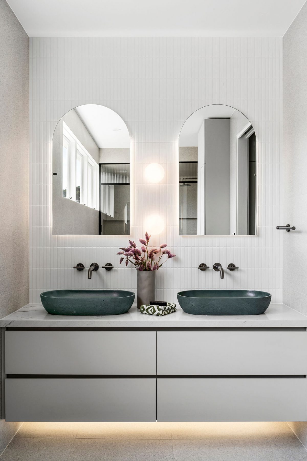 A custom designed bathroom featuring an olive green basin and brushed gunmetal tapware. Designed and built by MJ Harris Group. #MJHxGlencairnAve