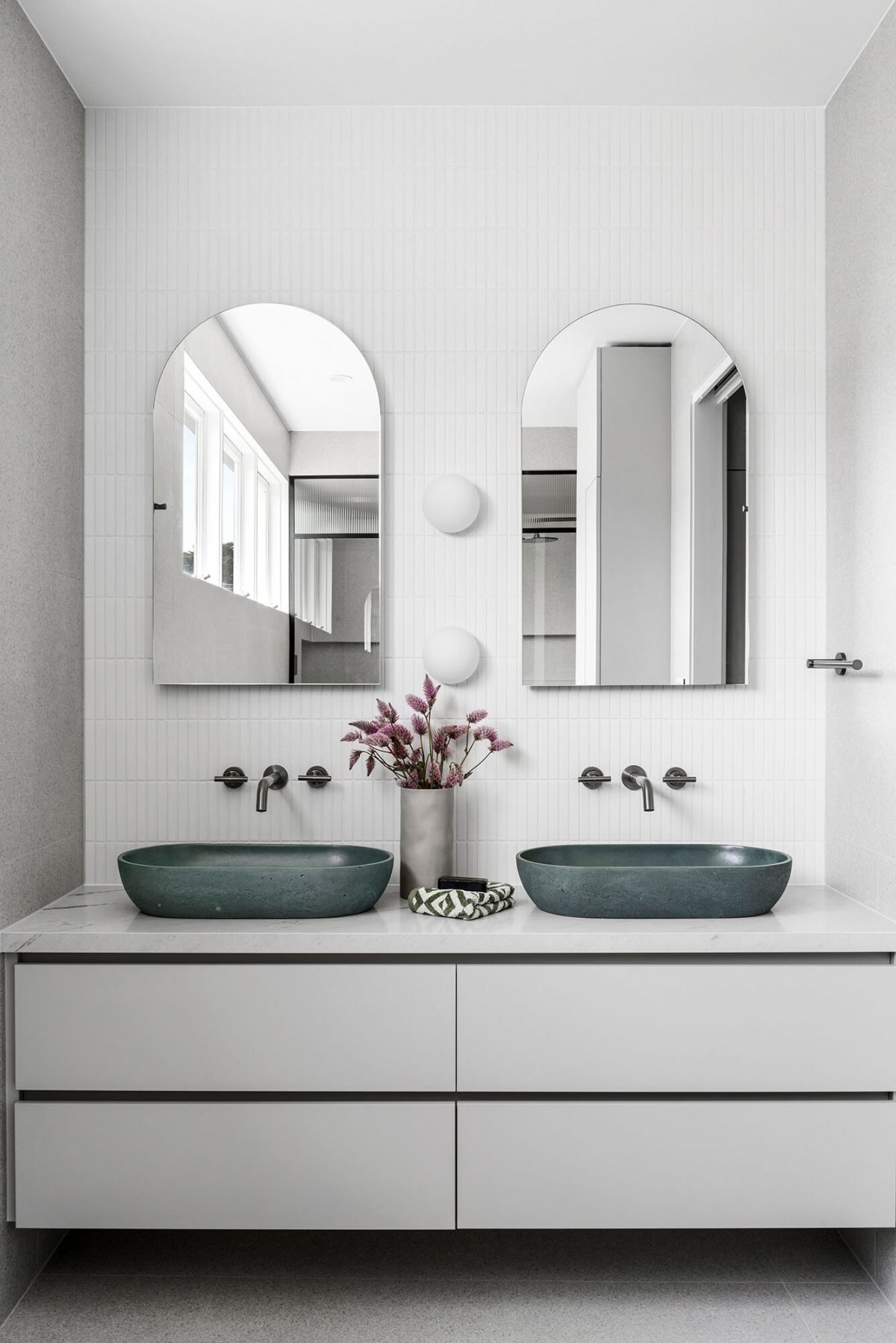 A custom designed bathroom featuring an olive green basin and brushed gunmetal tapware. Designed and built by MJ Harris Group. #MJHxGlencairnAve