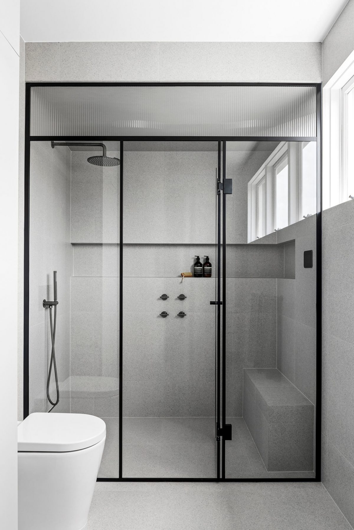 steam shower, brushed gunmetal tapware, wall-to-wall niche, shower seat, grey terrazzo til
