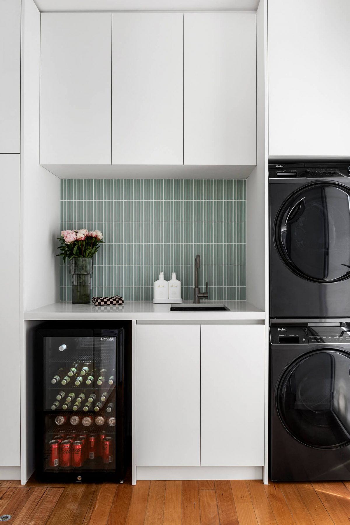 Brighton combined space kitchen renovation butlers pantry and laundry room green concave tiles, white custom joinery, brushed gunmetal tapware, black washing machine, black dryer, wine fridge