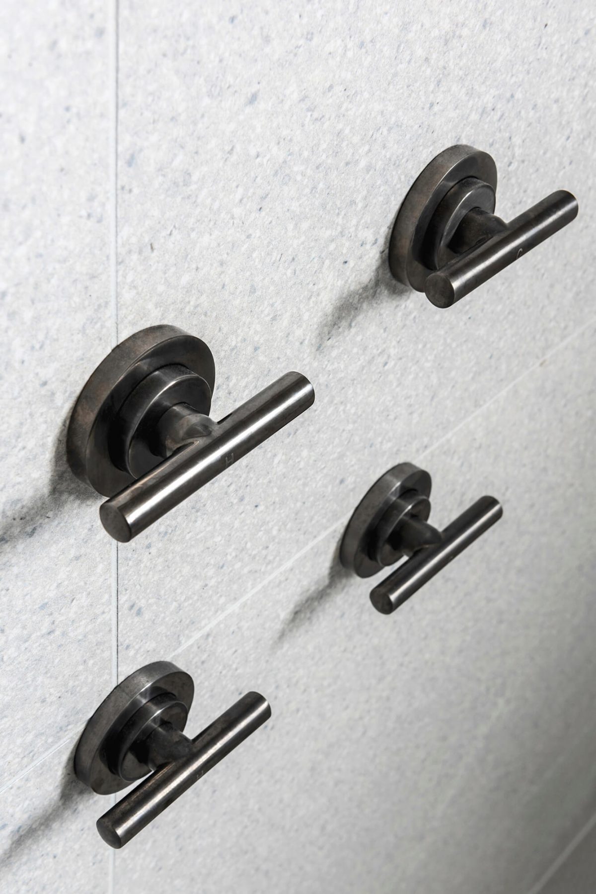 A custom designed bathroom featuring a steam shower with terrazzo tile and brushed gunmetal tapware. Designed and built by MJ Harris Group. #MJHxGlencairnAve