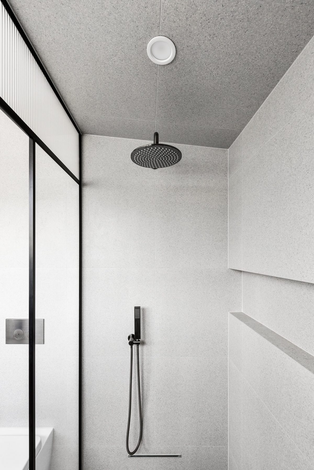 A custom designed bathroom featuring a steam shower with terrazzo tile and brushed gunmetal tapware. Designed and built by MJ Harris Group. #MJHxGlencairnAve