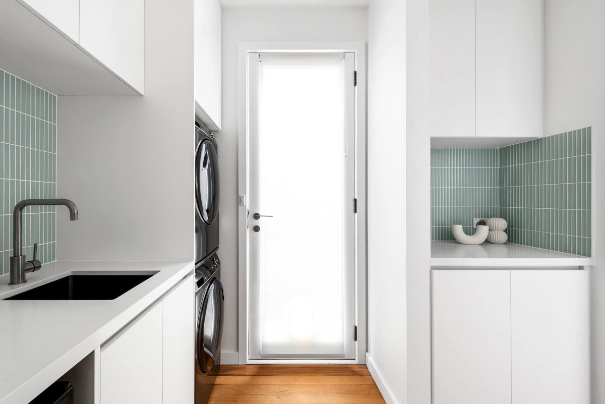 Combined Space kitchen renovation butlers pantry and laundry room green concave tiles, white custom joinery, brushed gunmetal tapware