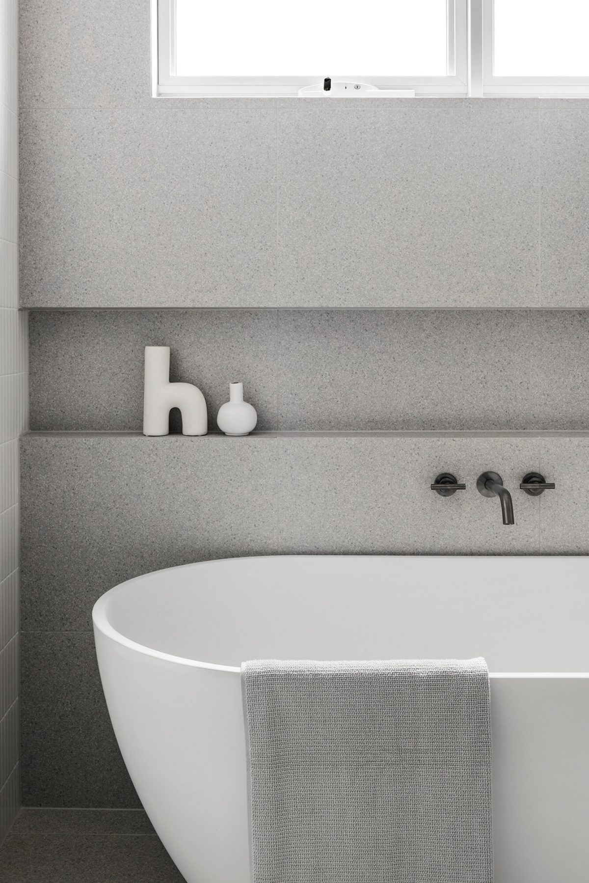 A custom designed bathroom featuring free standing bath tub with in wall niche and brushed gunmetal tapware. Designed and built by MJ Harris Group. #MJHxGlencairnAve