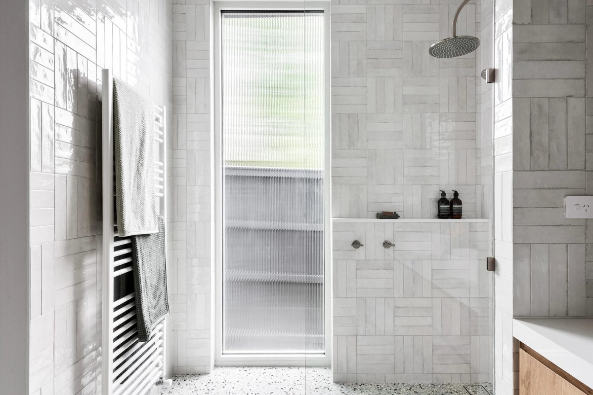 A custom designed ensuite bathroom featuring a walk in shower Melbourne Cross Hatch Spanish Subway Tiles. Designed and built by MJ Harris Group. #MJHxPeppinSt