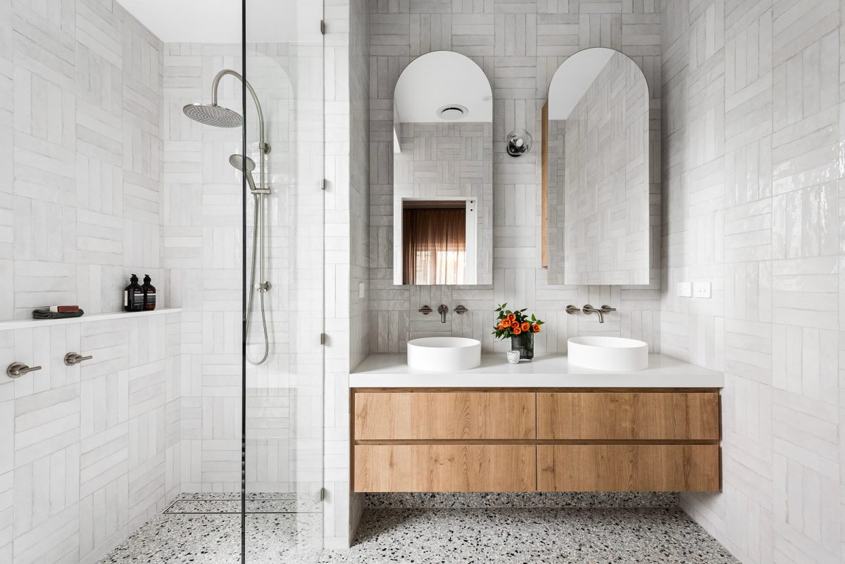 Custom-made Urban Oak double vanity bathroom renovation in Camberwell, Melbourne Arched Shaving Cabinet Brushed Nickel fixtures and fittings Spanish Subway Tiles Gooseneck Shower Head Natural Terrazzo Flooring Large Walk In Shower