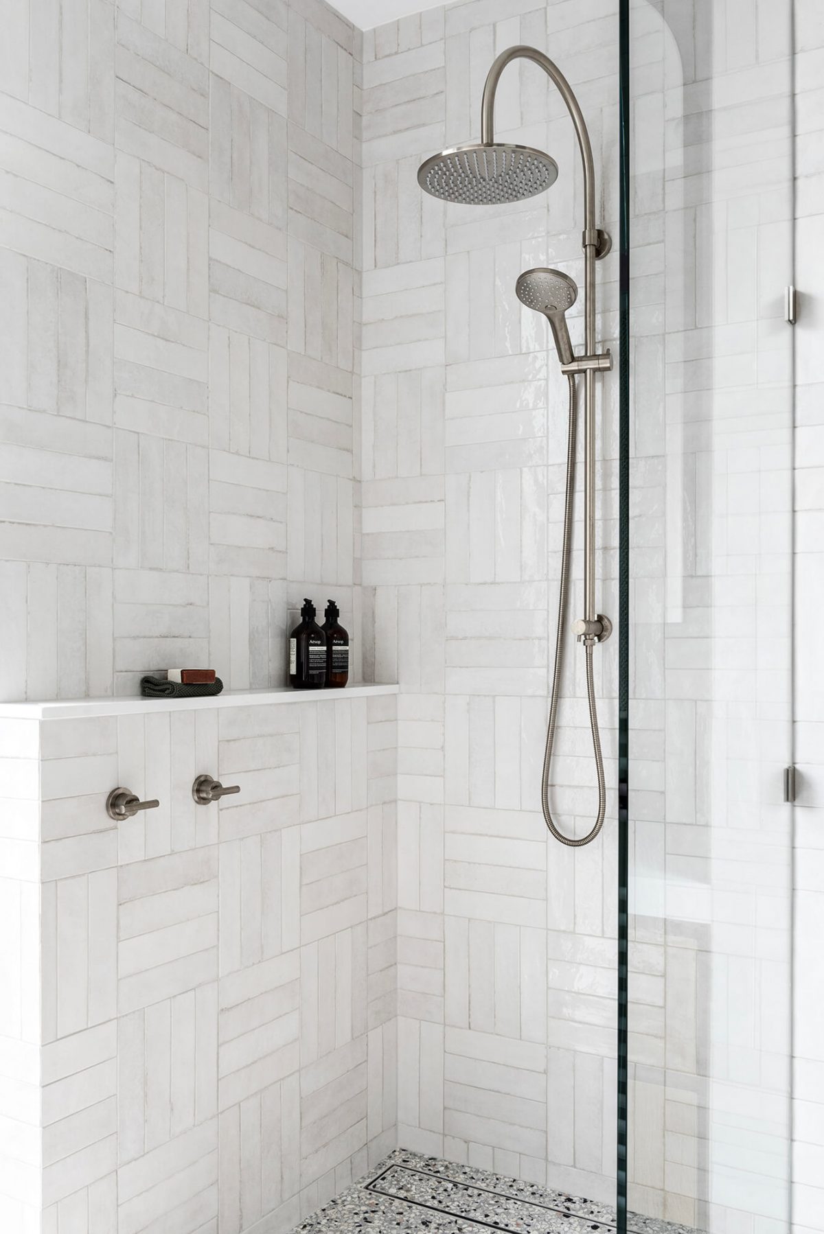 Melbourne Camberwell Ensuite Renovation Custom Interior Design Brushed Nickle Gooseneck Shower Head Tapware Crosshatch Tile Pattern Spanish Subway Tiles Natural Terrazzo Flooring Walk in Shower