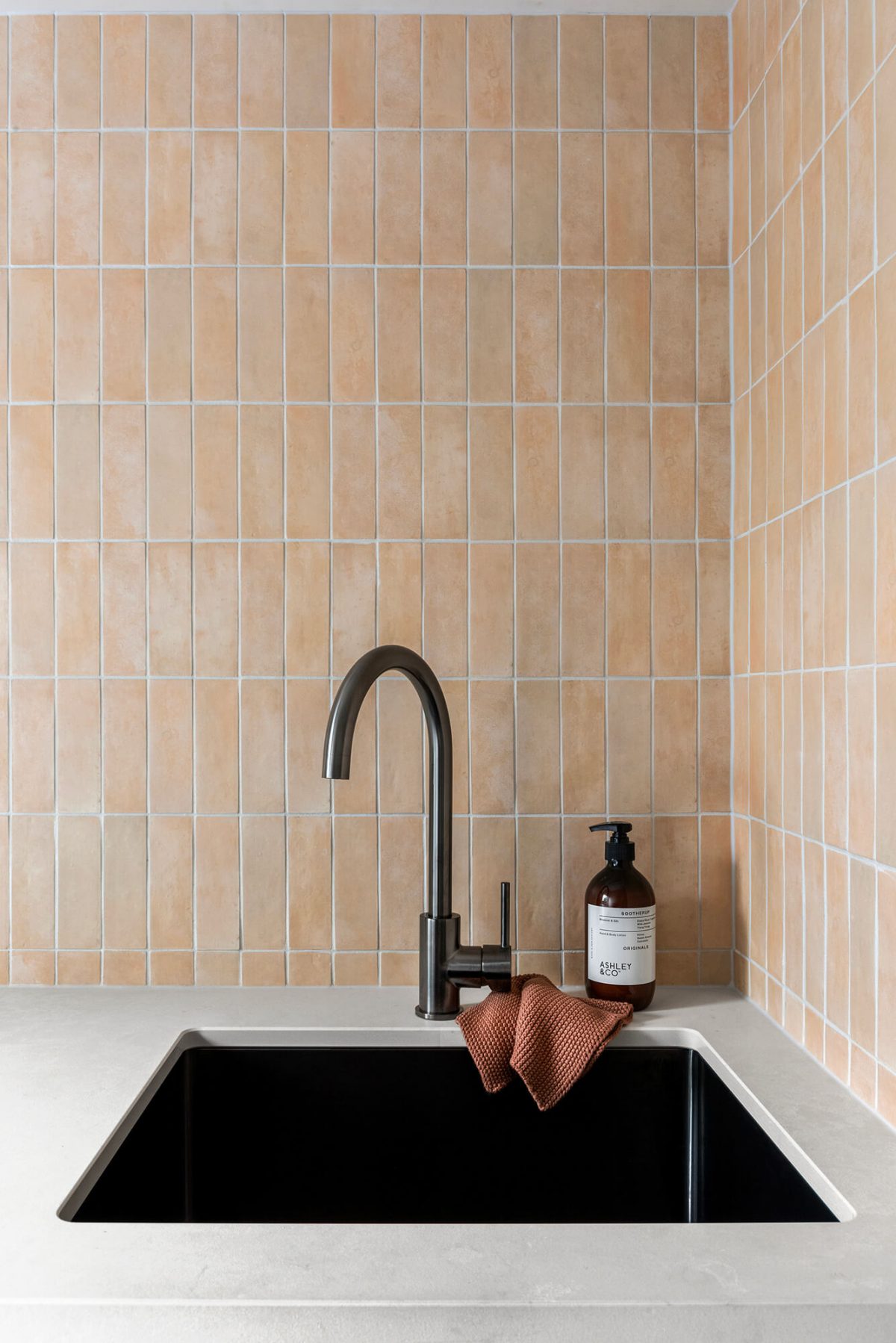 A custom designed laundry featuring moroccan terracotta file and gunmetal tapware. Designed and built by MJ Harris Group. #MJHxPeppinSt