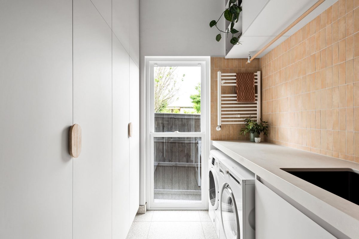 A custom designed laundry featuring moroccan terracotta file and gunmetal tapware. Designed and built by MJ Harris Group. #MJHxPeppinSt