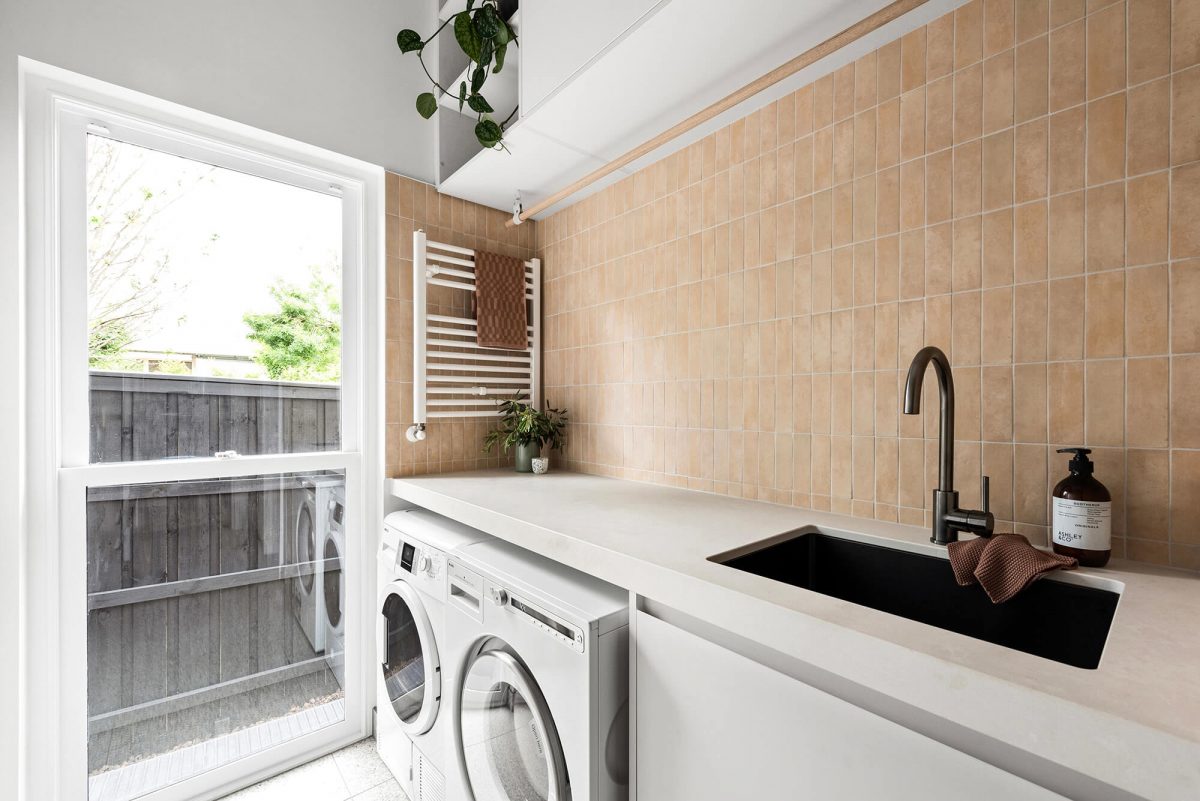 A custom designed laundry featuring moroccan terracotta file and gunmetal tapware. Designed and built by MJ Harris Group. #MJHxPeppinSt