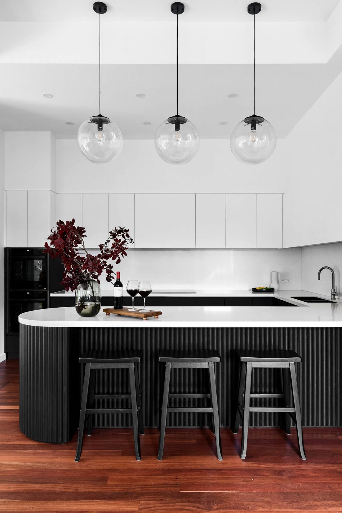 A custom designed kitchen featuring a monochromatic curved island bench. Designed and built by MJ Harris Group. #MJHxGrandviewGr