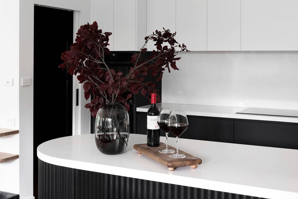 A custom designed kitchen featuring a monochromatic curved island bench. Designed and built by MJ Harris Group. #MJHxGrandviewGr