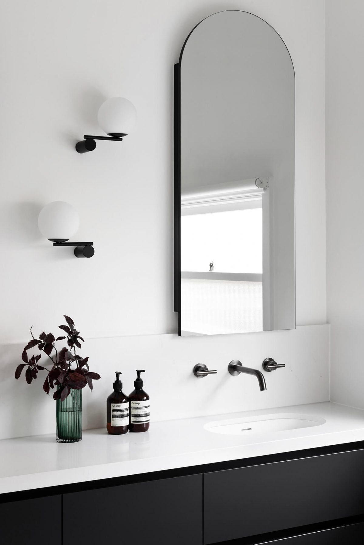 A custom designed bathroom featuring gunmetal fixtures and an arched mirror shaving cabinet. Designed and built by MJ Harris Group. #MJHxGrandviewGr