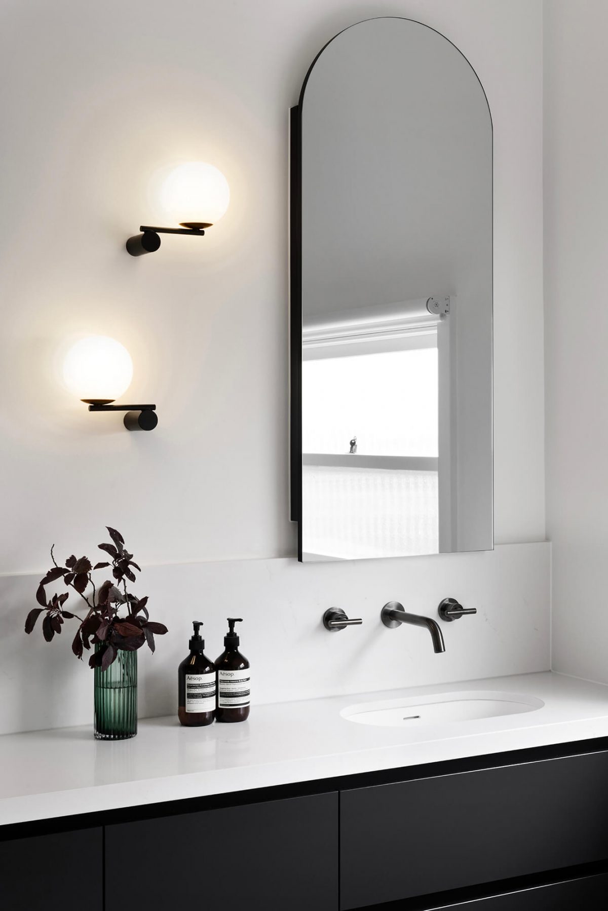 A custom designed bathroom featuring gunmetal fixtures and an arched mirror shaving cabinet. Designed and built by MJ Harris Group. #MJHxGrandviewGr