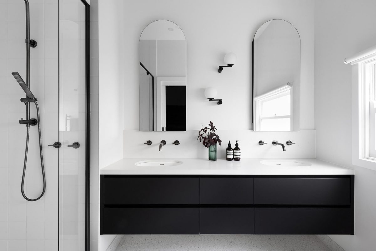 A custom designed bathroom featuring a double vanity with a arched mirror shaving cabinet. Designed and built by MJ Harris Group. #MJHxGrandviewGr