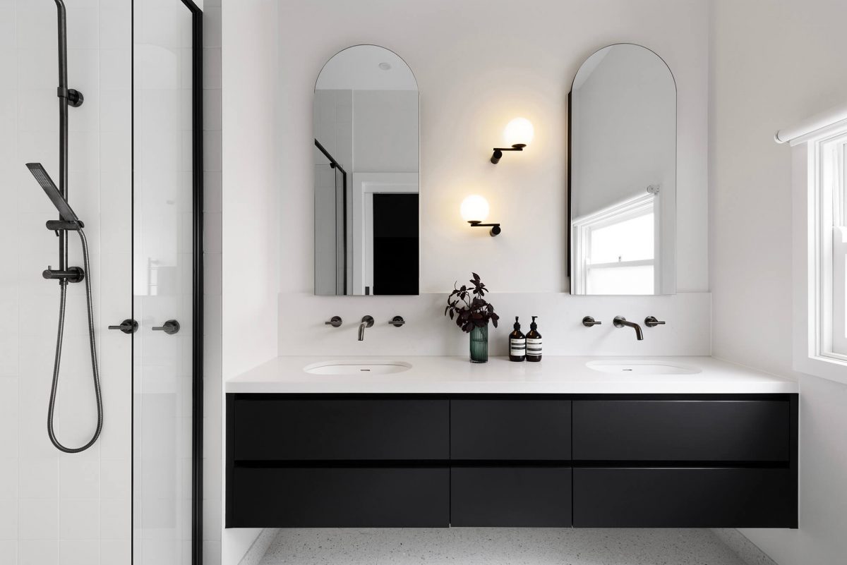 A custom designed bathroom featuring a double vanity with a arched mirror shaving cabinet. Designed and built by MJ Harris Group. #MJHxGrandviewGr