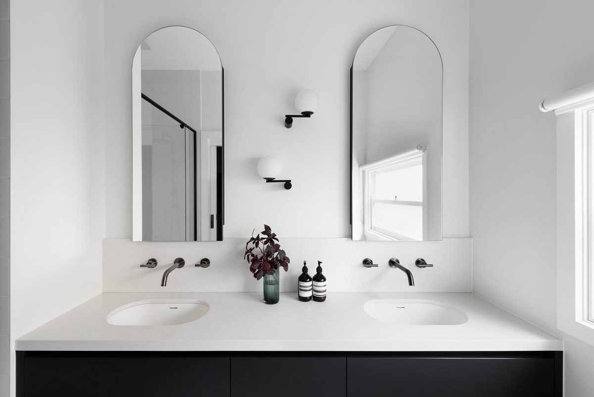 A custom designed bathroom featuring a double vanity with a arched mirror shaving cabinet. Designed and built by MJ Harris Group. #MJHxGrandviewGr