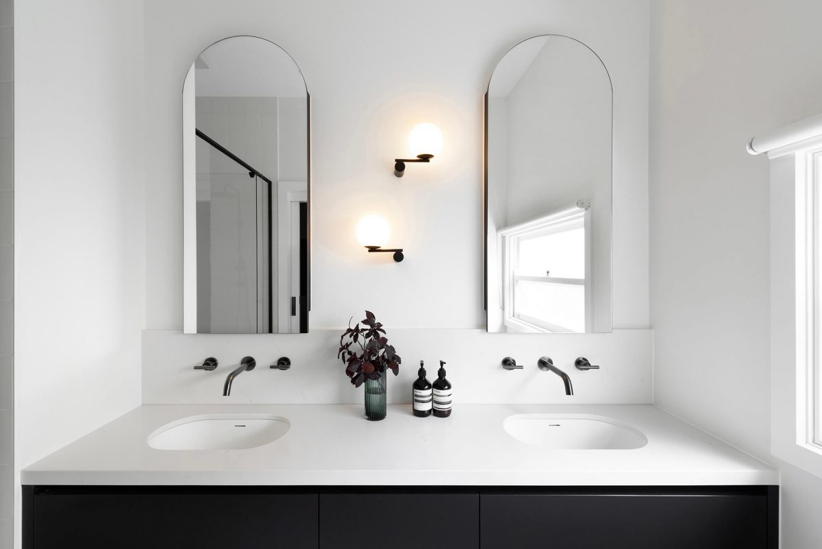 A custom designed bathroom featuring a double vanity with a arched mirror shaving cabinet. Designed and built by MJ Harris Group. #MJHxGrandviewGr