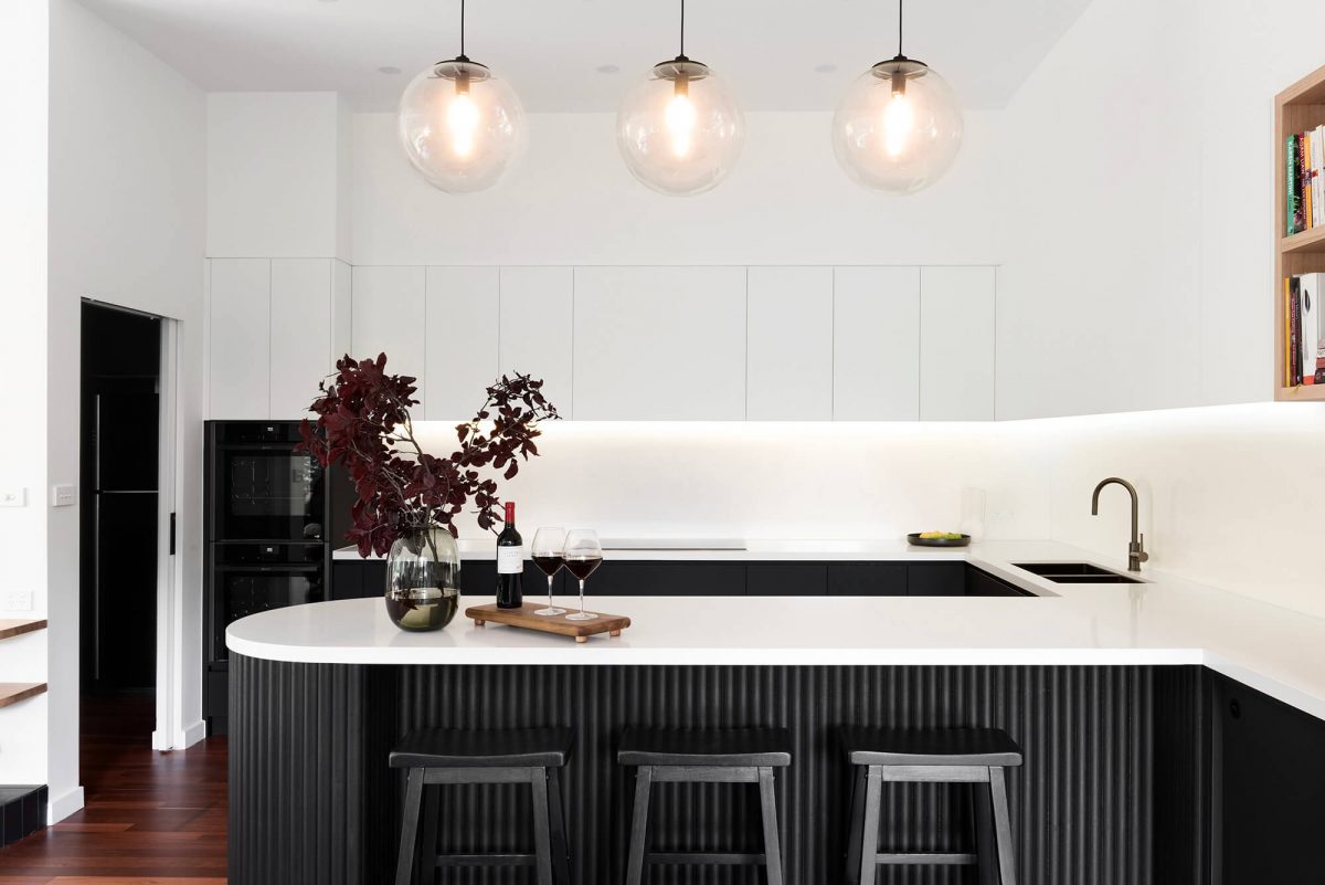 A custom designed kitchen featuring a monochromatic curved island bench. Designed and built by MJ Harris Group. #MJHxGrandviewGr
