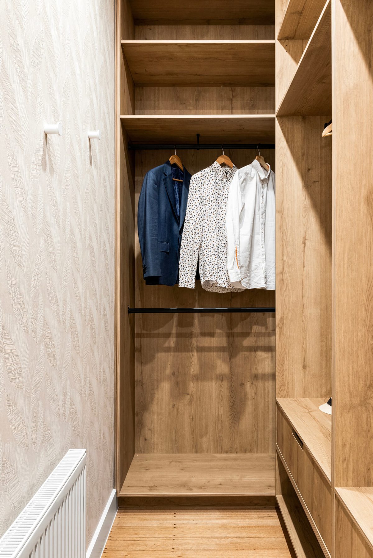 A custom designed walk in robe in the master bedroom featuring custom joinery and feature wallpaper. Designed and built by MJ Harris Group. #MJHxPeppinSt