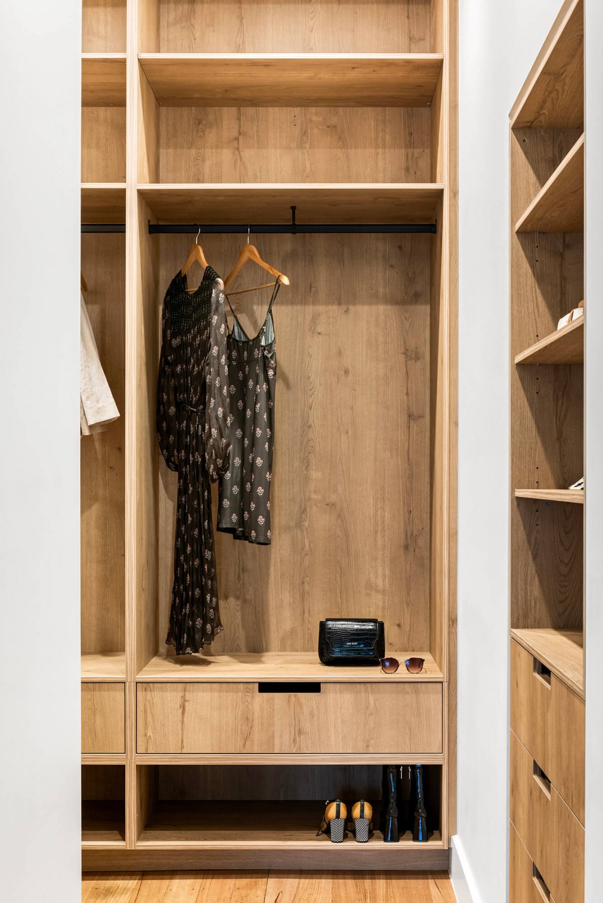 A custom designed walk in robe in the master bedroom featuring custom joinery and feature wallpaper. Designed and built by MJ Harris Group. #MJHxPeppinSt