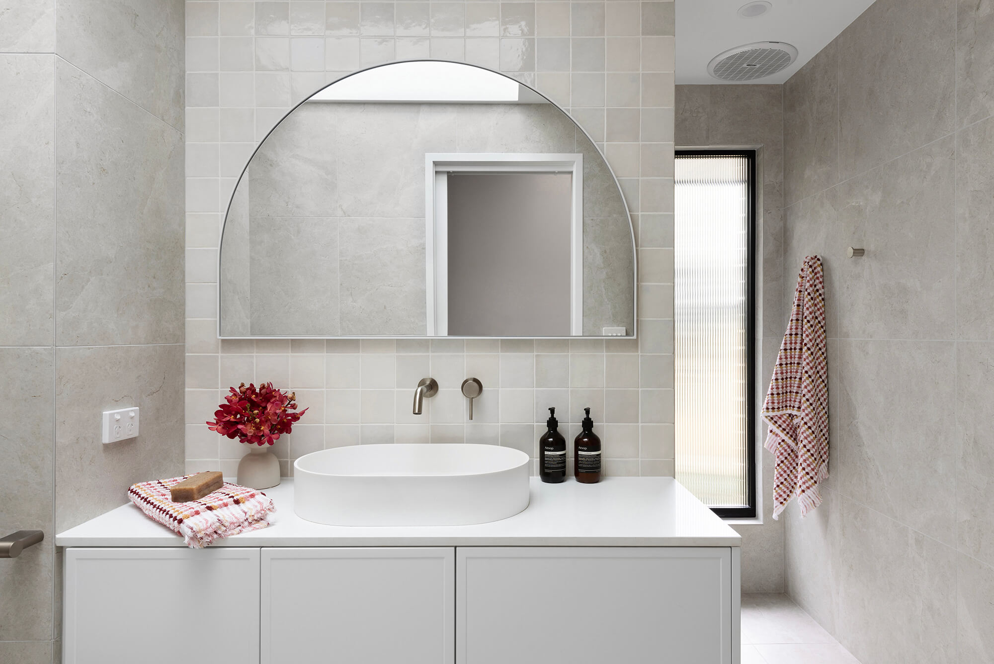 A custom designed bathroom featuring a Melange Bianco tile. Designed and built by MJ Harris Group.