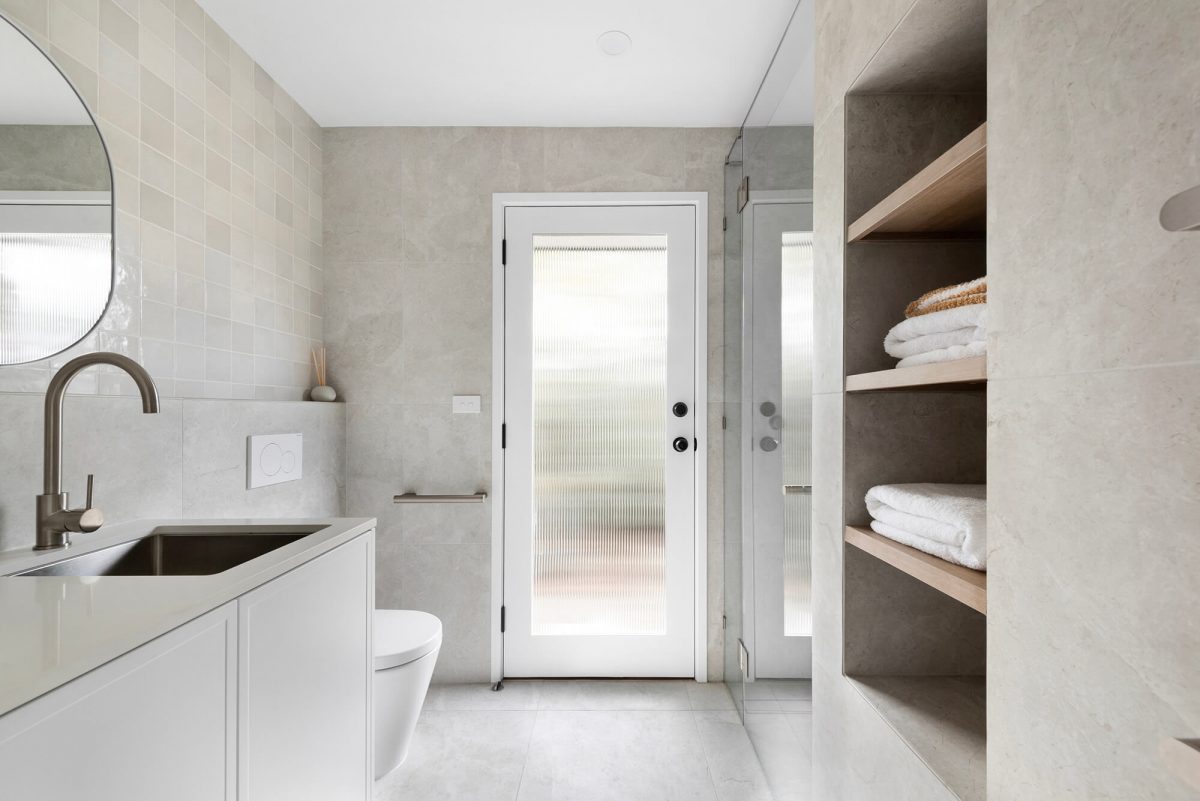 A custom designed bathroom featuring a Melange Bianco tile. Designed and built by MJ Harris Group. #MJHxWallisAve