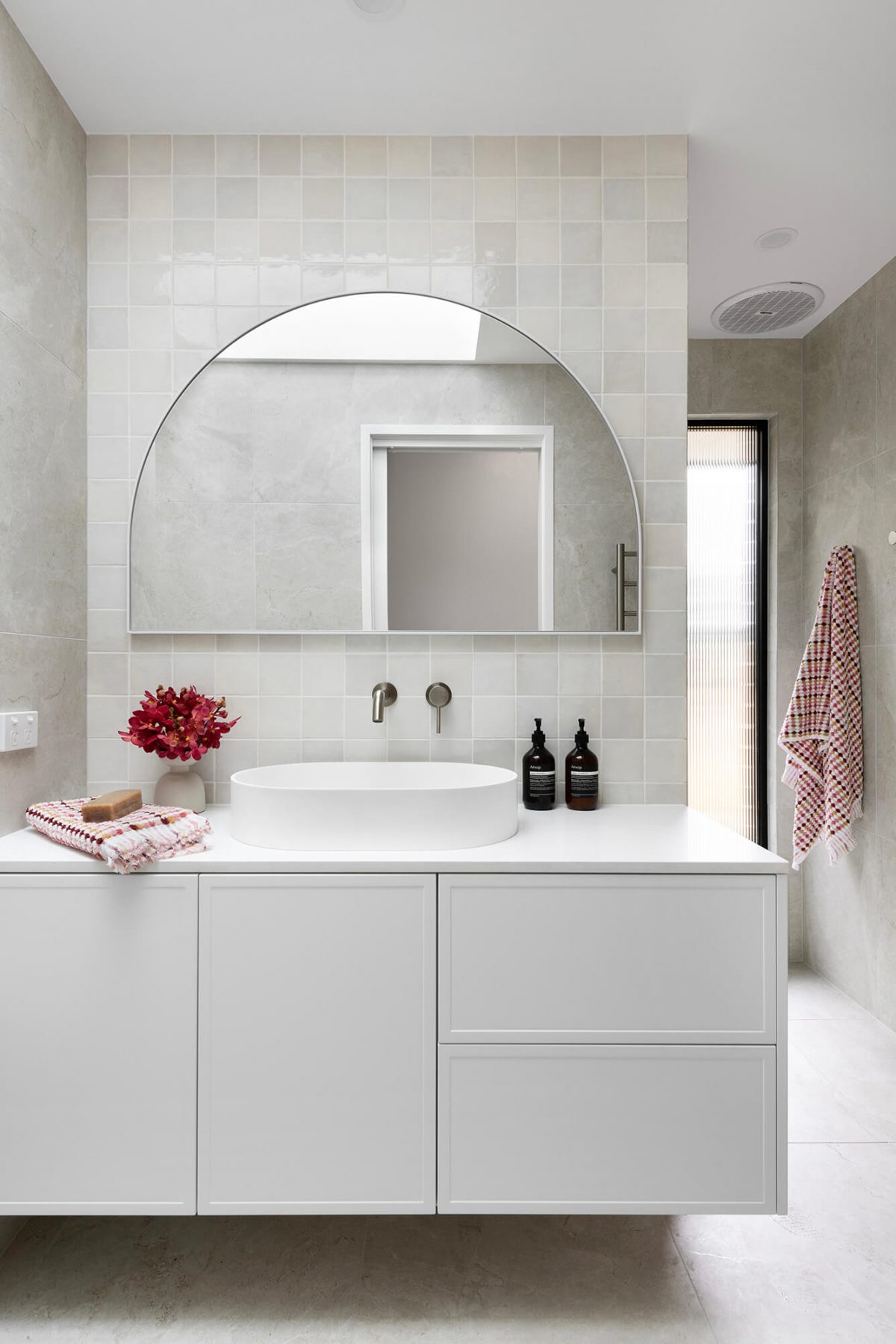A custom designed bathroom featuring a Melange Bianco tile. Designed and built by MJ Harris Group. #MJHxWallisAve
