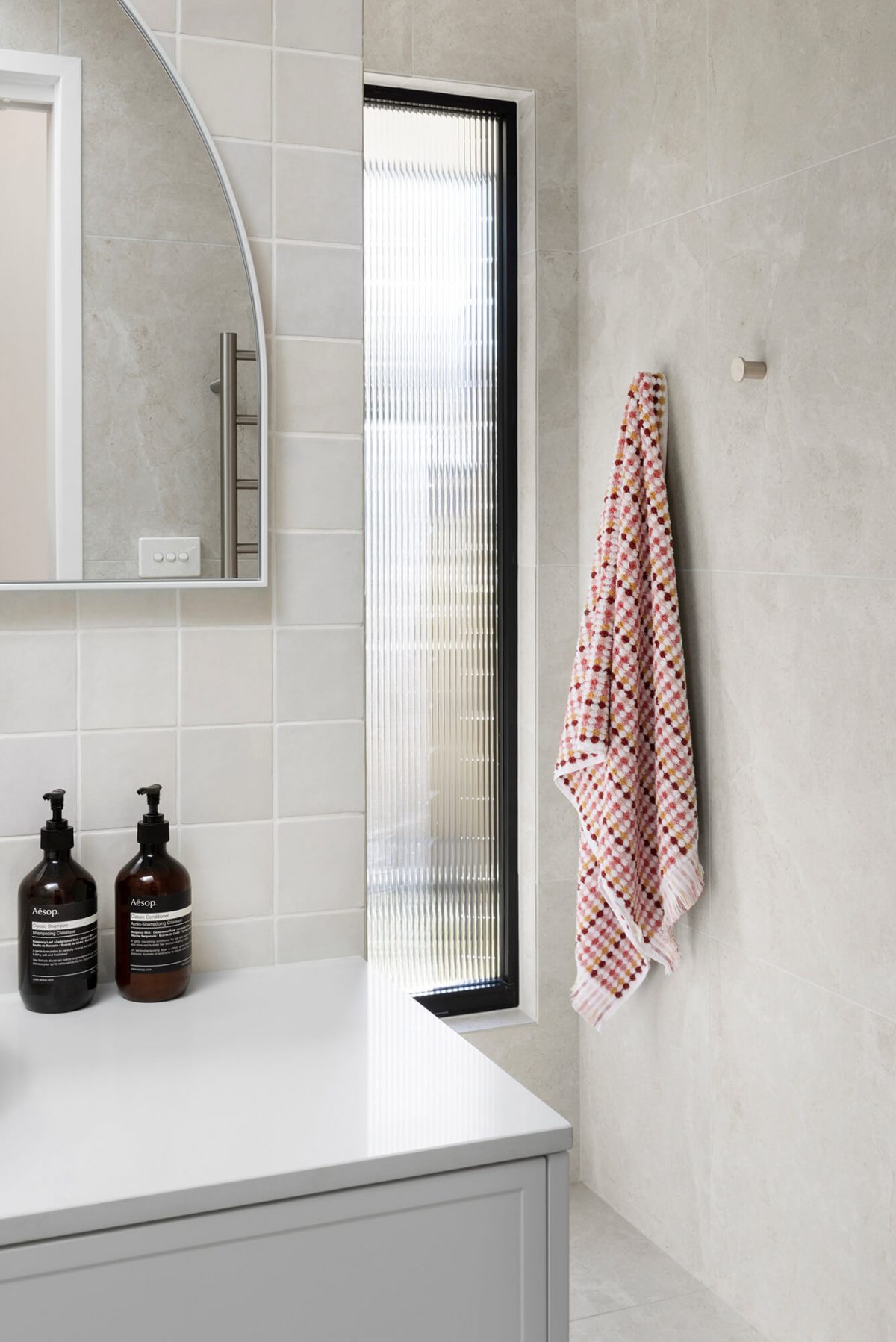 A custom designed bathroom featuring a Melange Bianco tile. Designed and built by MJ Harris Group. #MJHxWallisAve