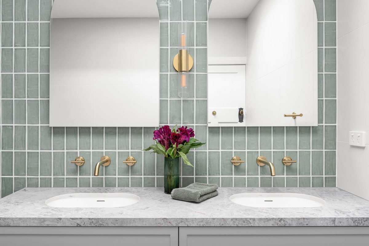 A custom designed bathroom featuring green tiles. Designed and built by MJ Harris Group. #MJHxOrrrongCt
