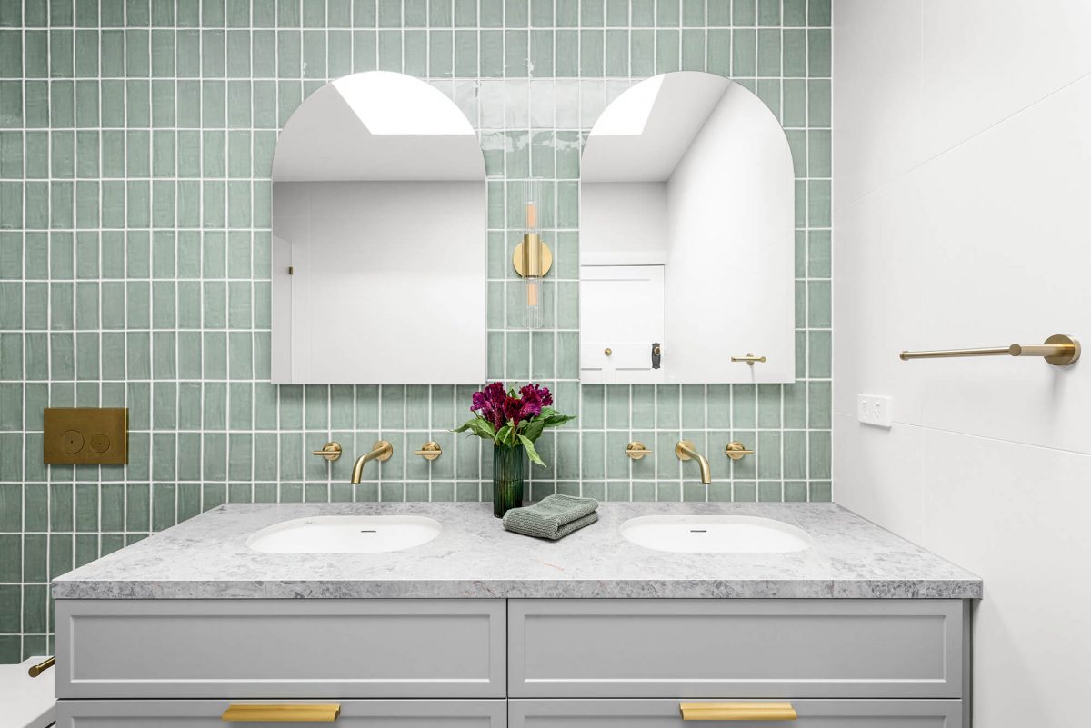 A custom designed bathroom featuring green joinery. Designed and built by MJ Harris Group. #MJHxOrrrongCt