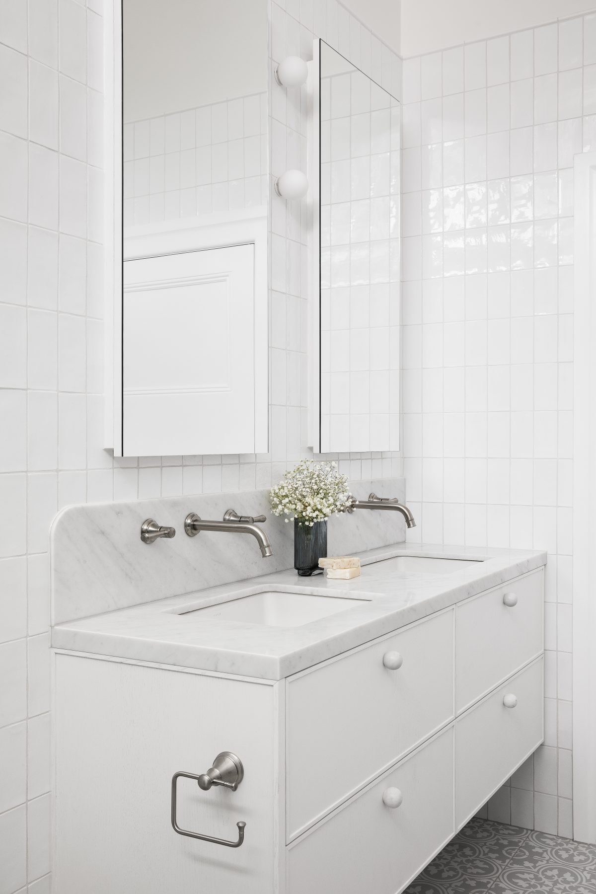 A custom designed bathroom featuring Spanish Handmade White Gloss tiles and a Carrara Marble bench top. Designed and built by MJ Harris Group.