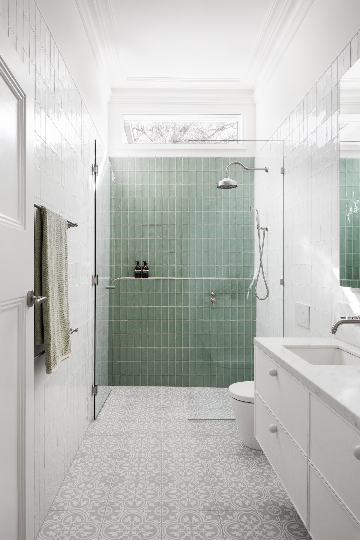 A custom designed bathroom featuring Spanish Handmade White Gloss tiles in White and Sage. Designed and built by MJ Harris Group.