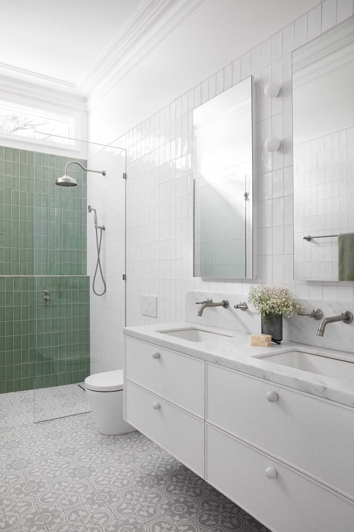 A custom designed bathroom featuring Spanish Handmade White Gloss tiles in White and Sage. Designed and built by MJ Harris Group.